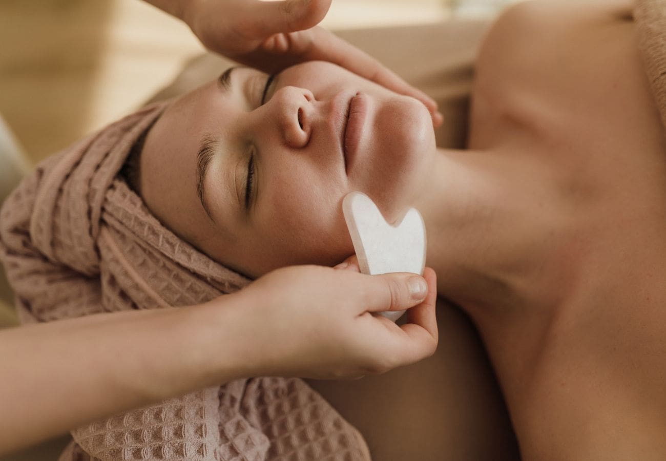 Woman at a medical spa having her face treated with body contouring